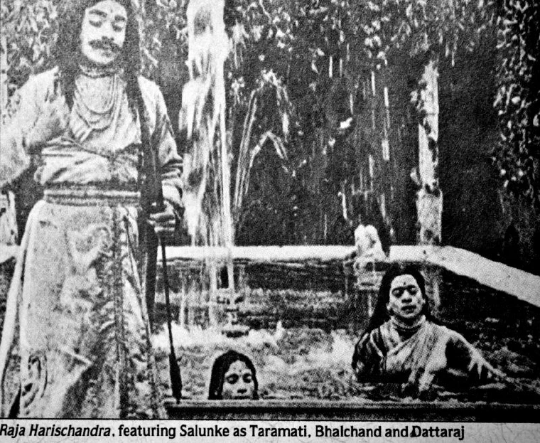 Black-and-white still from the 1913 silent film Raja Harishchandra showing costumed actors in a palace scene
