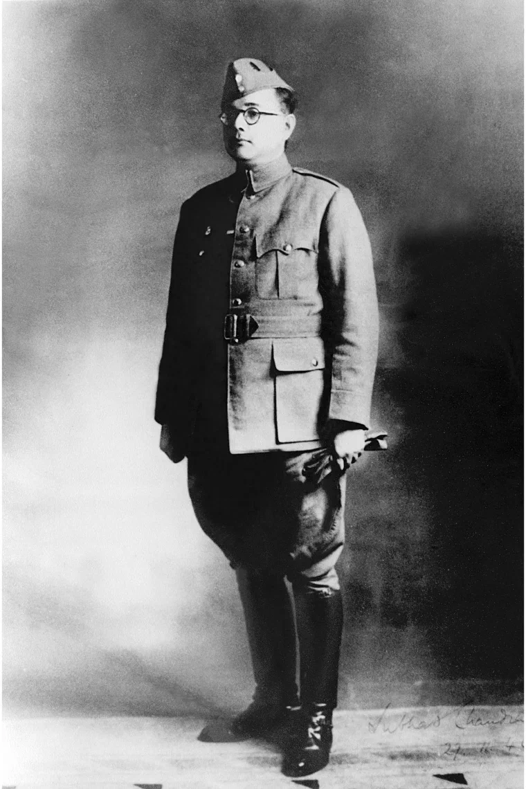 Photograph of Subhas Chandra Bose standing in Indian National Army uniform, cap and round glasses, hands at his sides