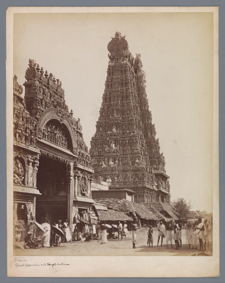 Nineteenth-century photograph of a towering carved gateway at the Meenakshi temple in Madurai, crowded with sculpted figures